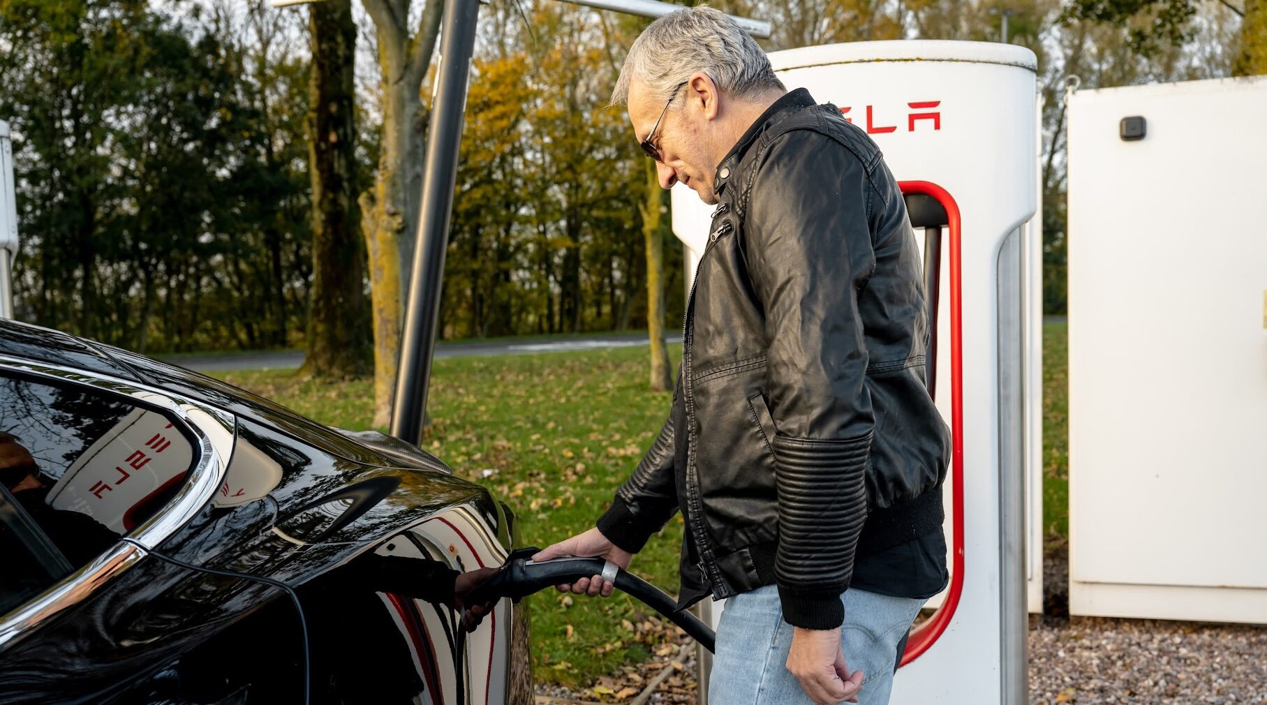 Man charging electric vehicle